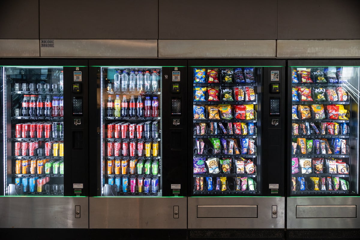 Fully stocked vending machines with beverages and packaged snacks