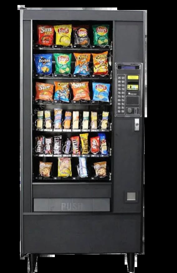Vending machine stocked with snack bags and candy products displayed in six rows with coin and bill payment slots on the right side