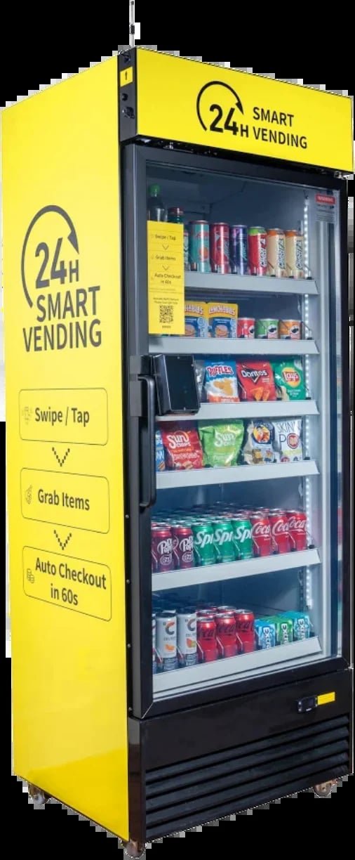 Yellow 24-hour smart vending machine stocked with snacks and beverages, featuring touchless payment and auto-checkout capabilities